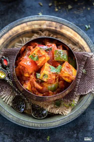 paneer and bell peppers served in a copper bowl