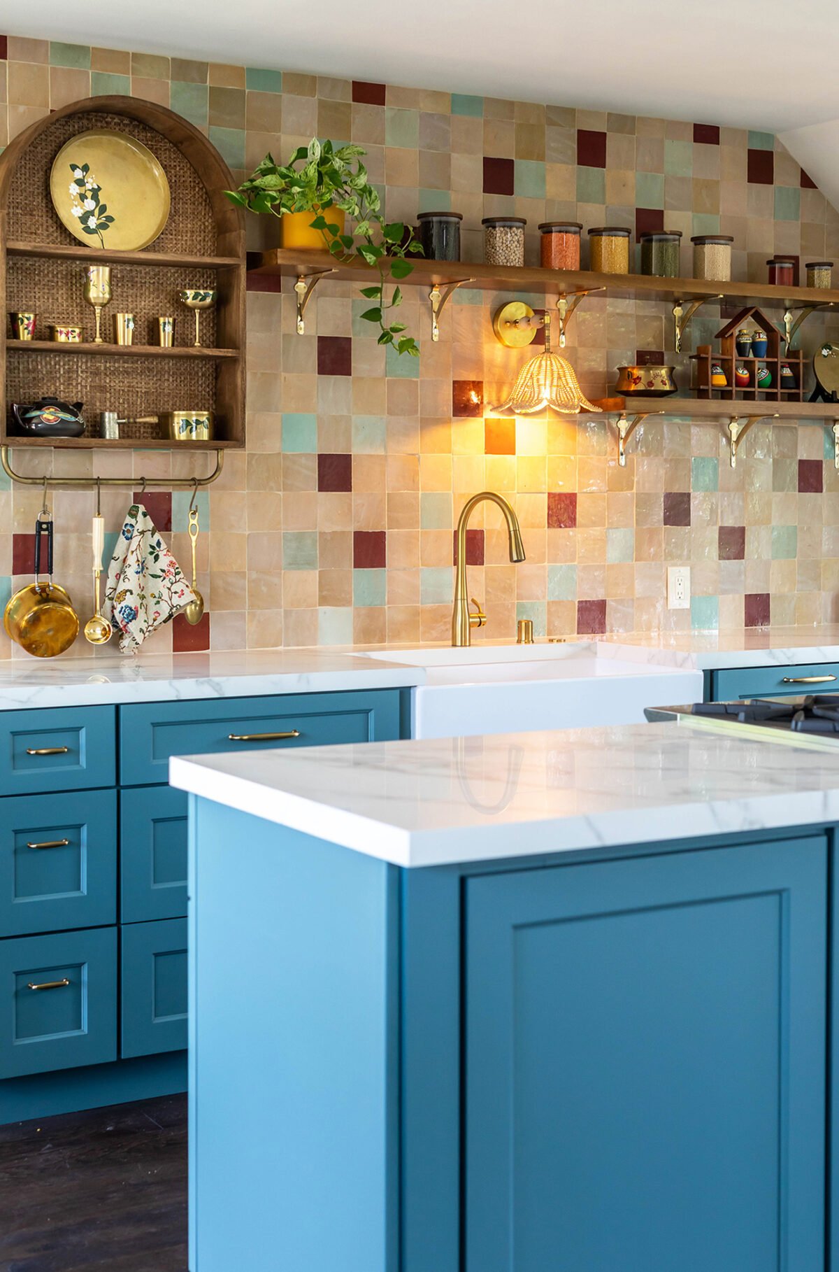 a kitchen with colorful tiles in the back
