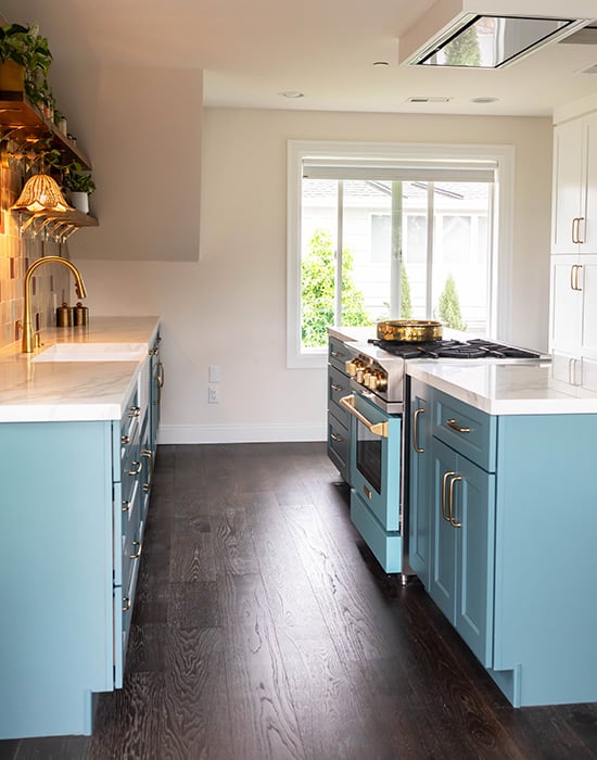a small kitchen with blue cabinets