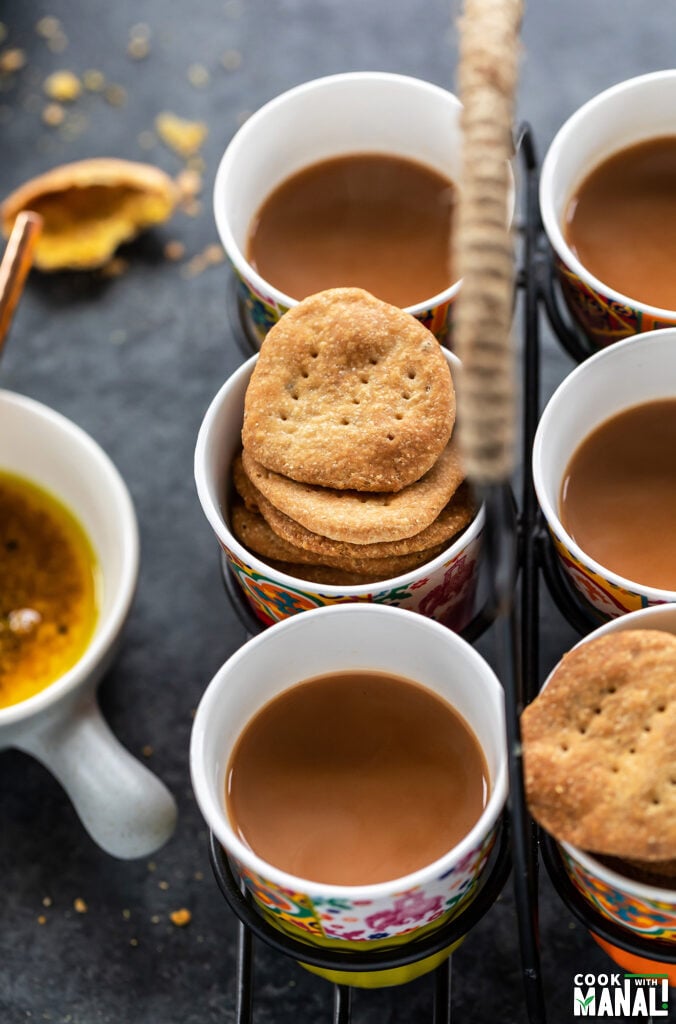 mathris arranged with glasses of chai in a glass holder