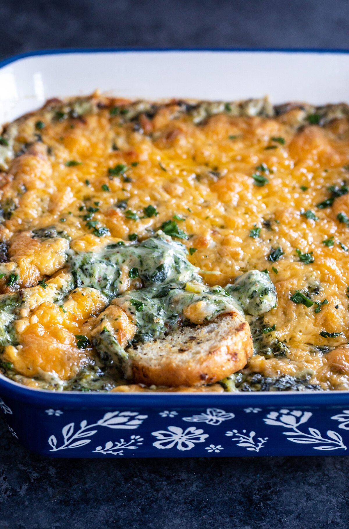 cheesy dip with a toasted baguette slice dipped into it