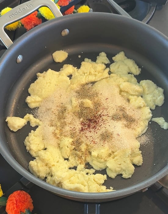 mawa with cardamom and saffron in a pan