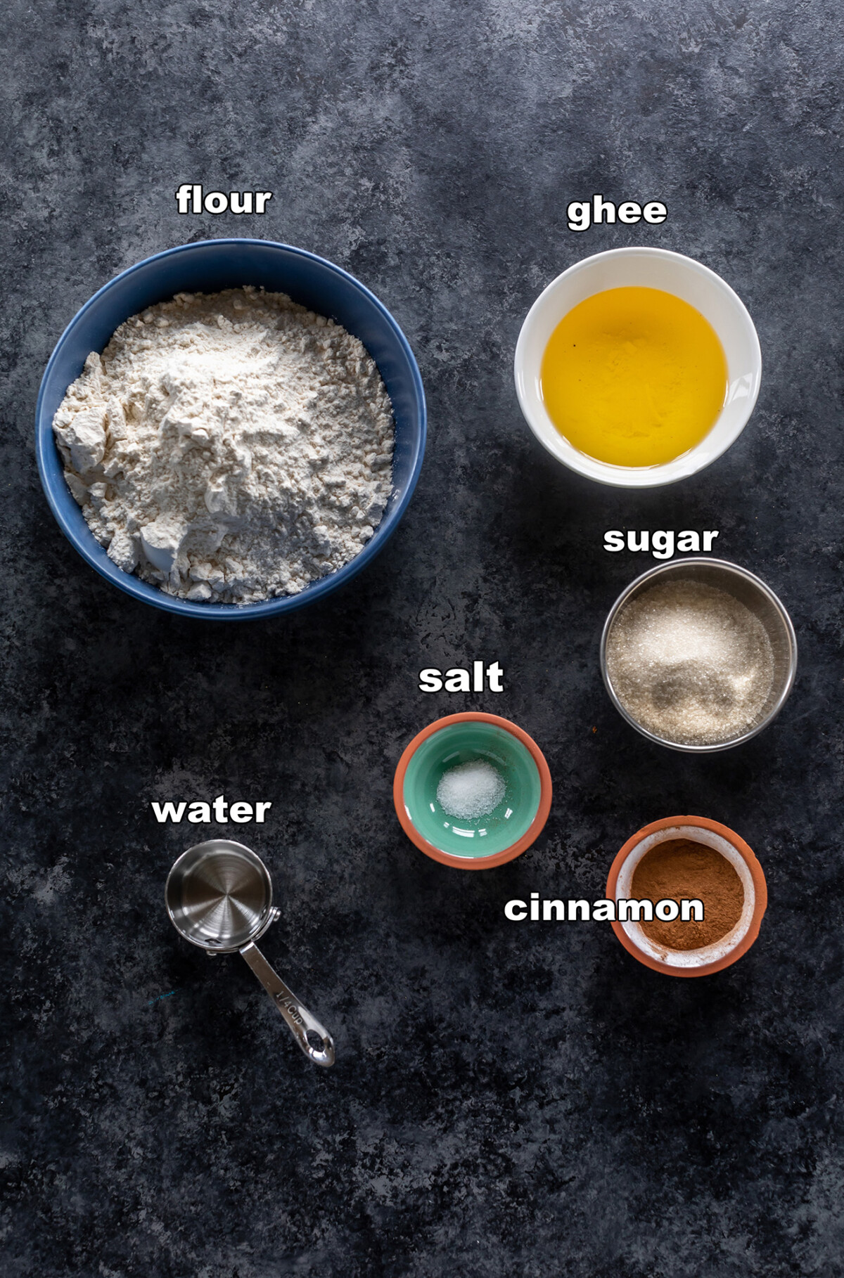 ingredients for cinnamon sugar shakarpara arranged on a board