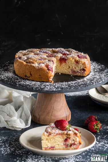 sliced strawberry cake on a black cake stand