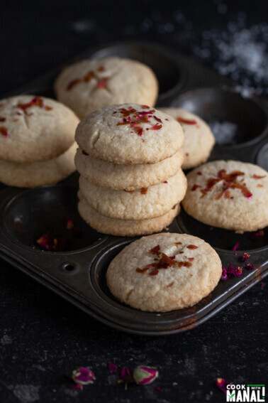 stack of cookies on a tray with more cookies on the side