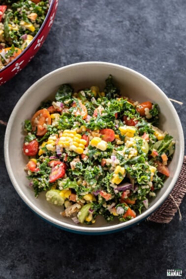 bowl of salad with kale, corn, cherry tomatoes
