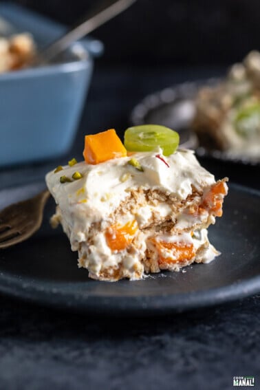 piece of icebox cake showing layers of cream, fresh fruits and cookies