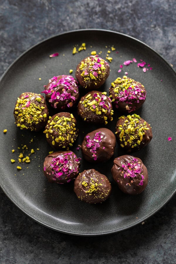 gujiya truffles coated with dried rose petals and crushed pistachios