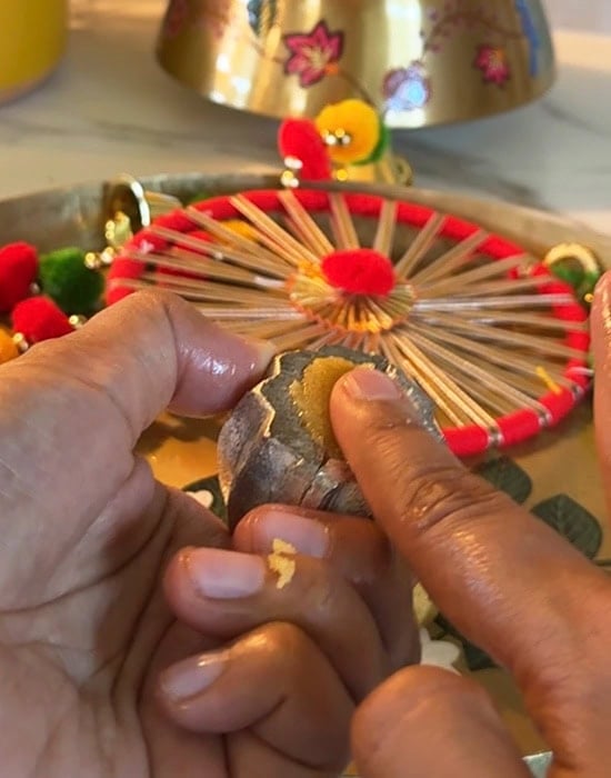 a finger pushing the mawa inside the mold