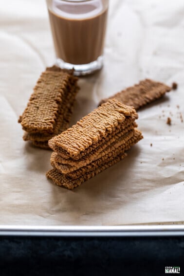 stack of atta biscuits with chai place in the background
