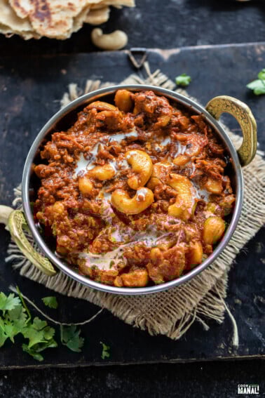 cashews with spices served in a copper kadai