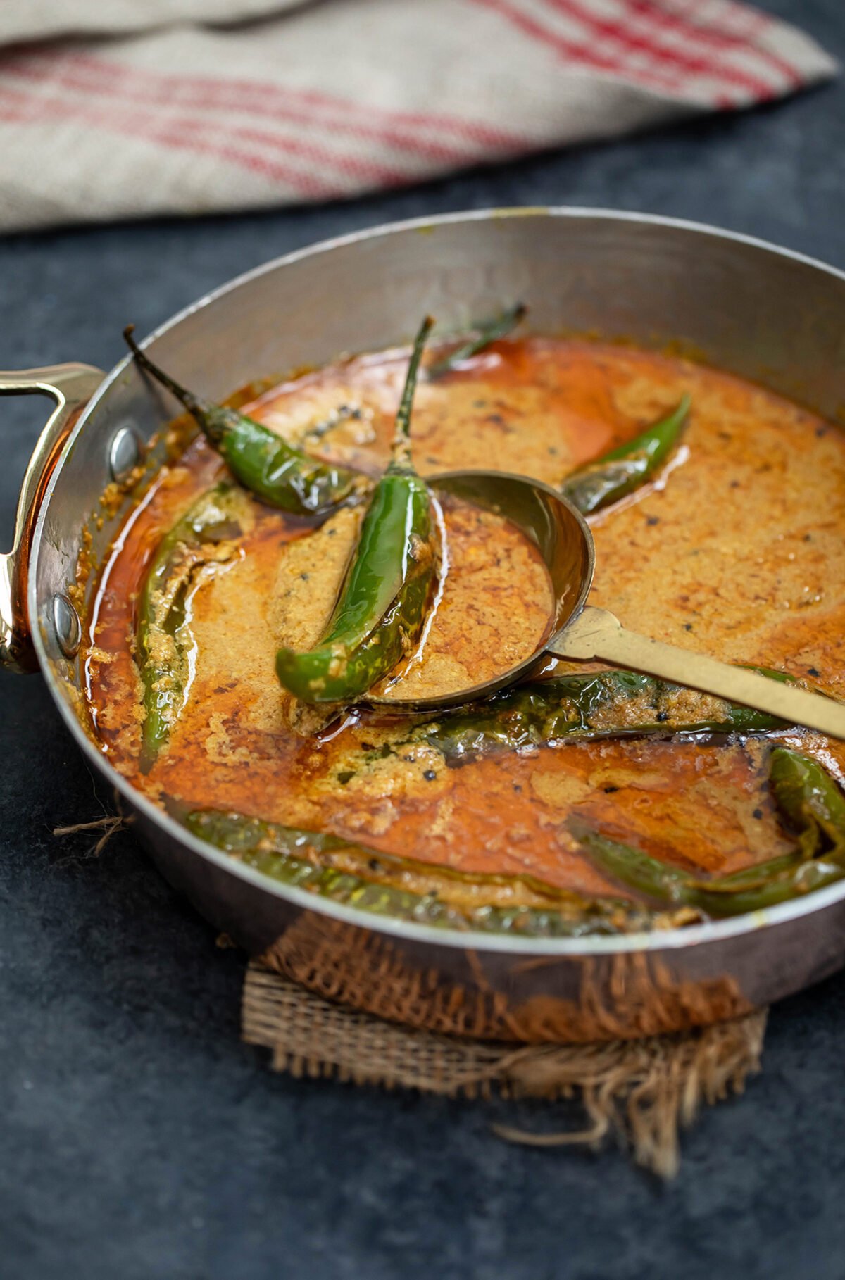 green chili in a ladle in a curry