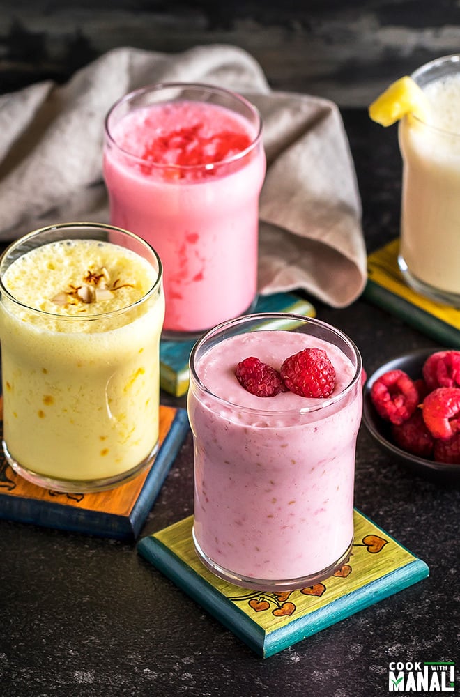 four glasses of lassi on coasters
