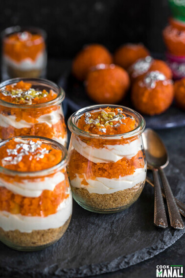 jars of motichoor cheesecake ladoo with spoon on the side and motichoor ladoo in the background