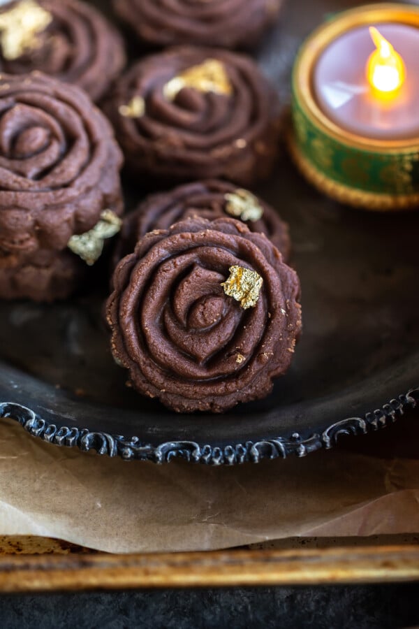 peda served on a silver plate with diya on the side