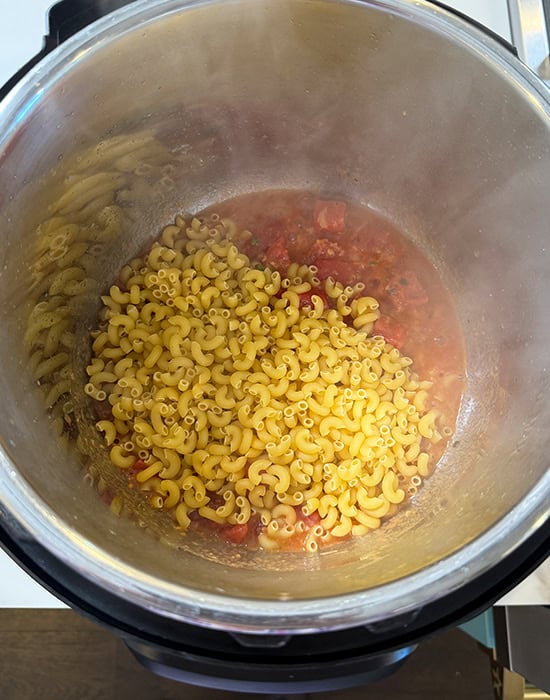 elbow pasta being added to instant pot