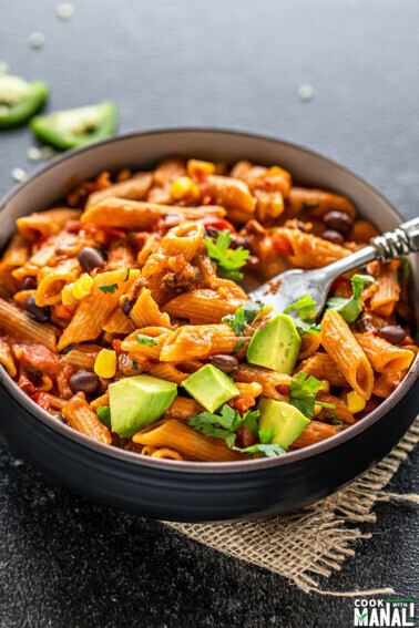 southwestern pasta served in a black bowl with a fork