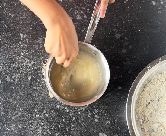 sugar being whisked with water