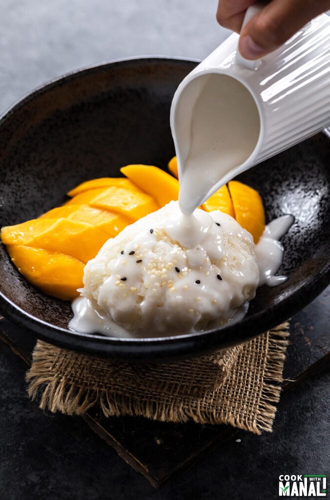 coconut sauce being drizzled over sticky rice