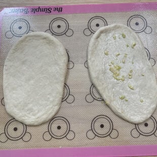 rolled naans with 1 sprinkled with garlic