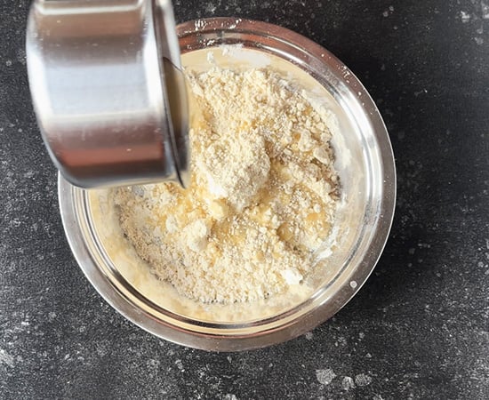 water sugar mixture being added to flour