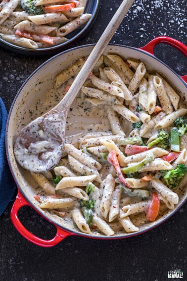 bowl of white sauce pasta with veggies
